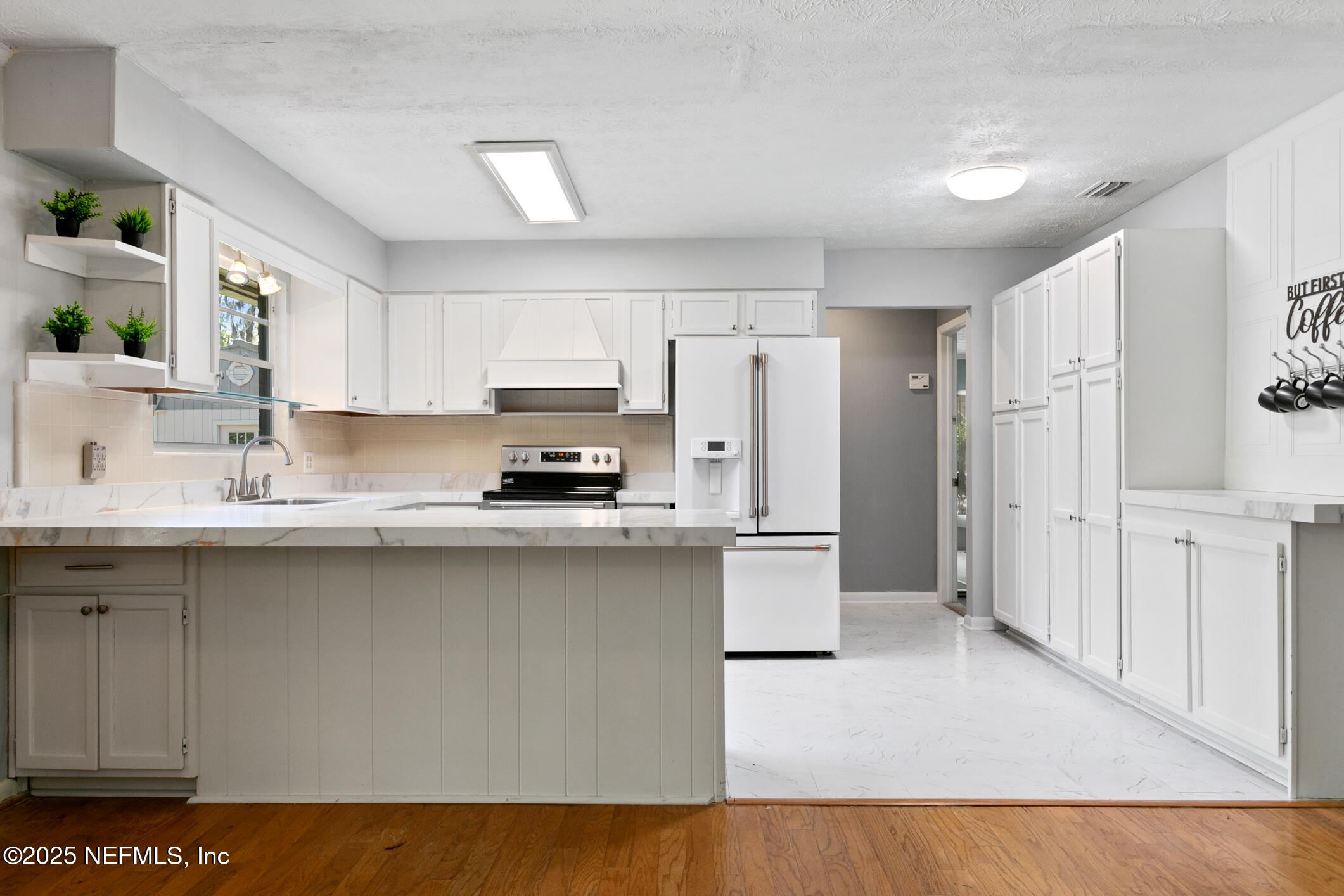 12657 Aladdin Road Jacksonville, FL 32223 - Photo 8 of 47 a kitchen with stainless steel appliances a sink a stove a refrigerator and cabinets