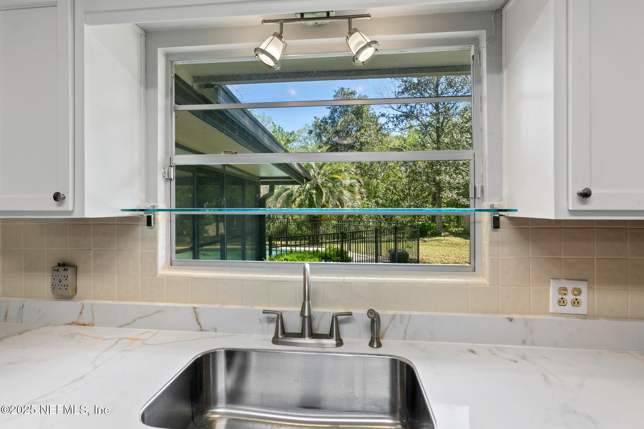 12657 Aladdin Road Jacksonville, FL 32223 - Photo 9 of 47 a kitchen with a sink and a window