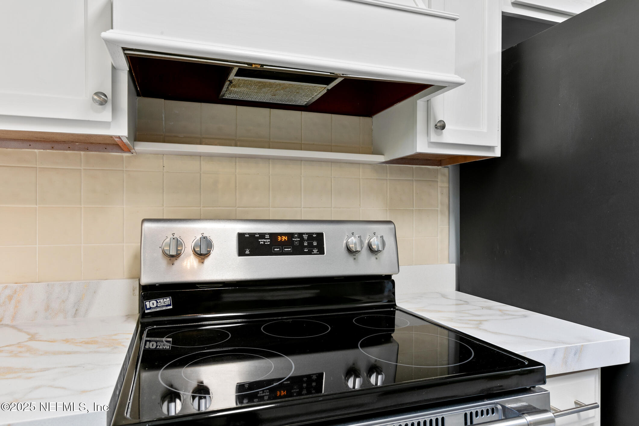 12657 Aladdin Road Jacksonville, FL 32223 - Photo 10 of 47 a stove top oven sitting inside of a kitchen