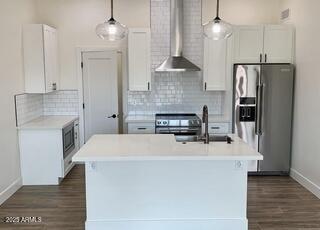 3933 East Rancho Drive Paradise Valley, AZ 85253 - Photo 12 of 27 a kitchen with stainless steel appliances a refrigerator sink and stove