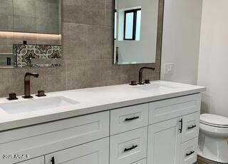 3933 East Rancho Drive Paradise Valley, AZ 85253 - Photo 13 of 27 a bathroom with a sink and a toilet