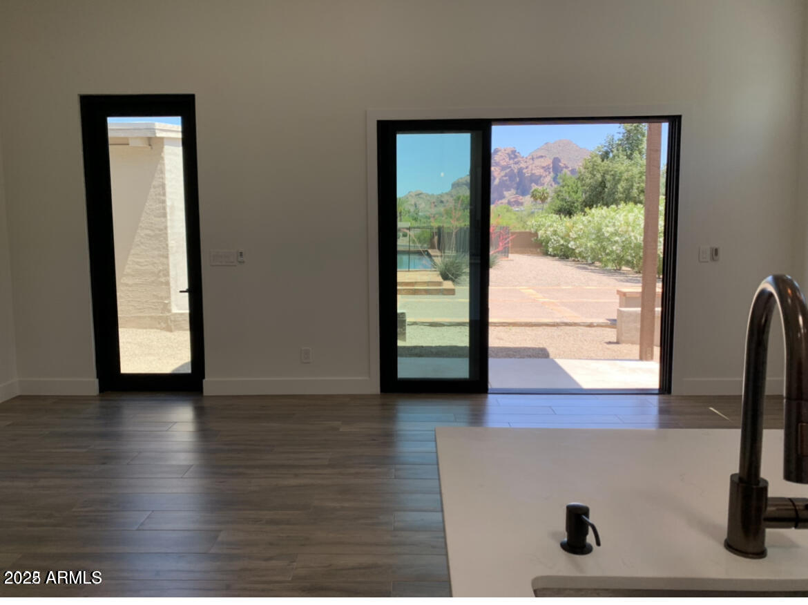 3933 East Rancho Drive Paradise Valley, AZ 85253 - Photo 10 of 27 an empty room with wooden floor and windows