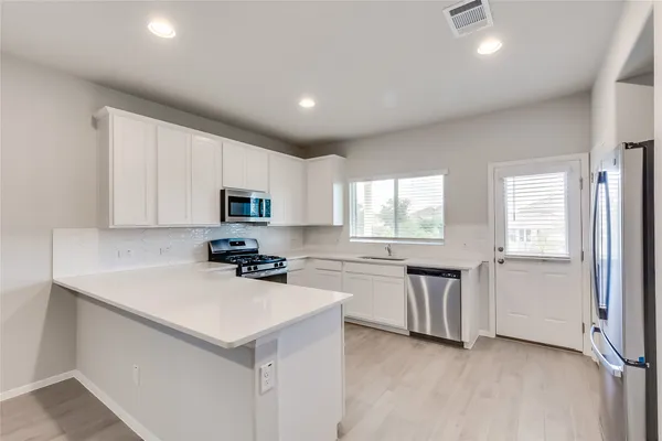 a kitchen with sink cabinets and microwave