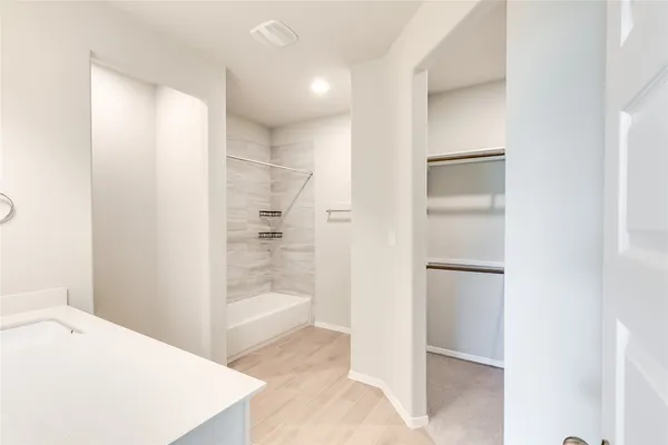 a room with a bed and a refrigerator