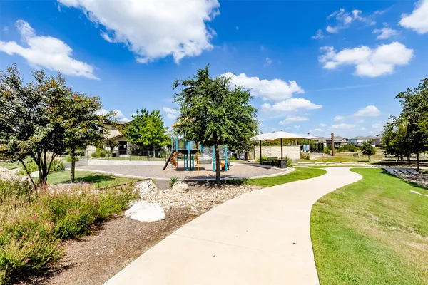 a view of a house with swimming pool and sitting area
