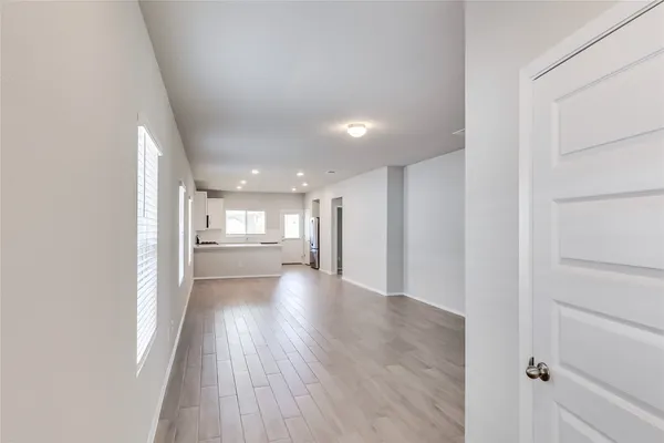a view of a hallway with wooden floor