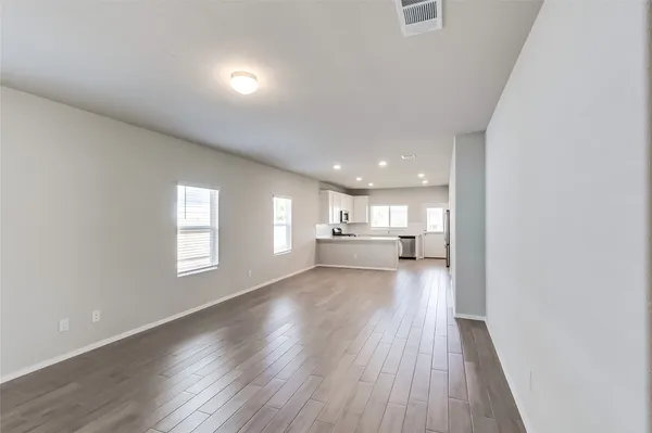 a view of a kitchen and wooden floor