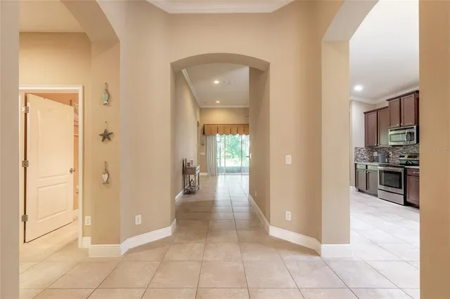 a view of a hallway to rooms and kitchen