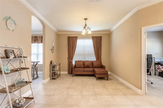 a living room with furniture and a chandelier