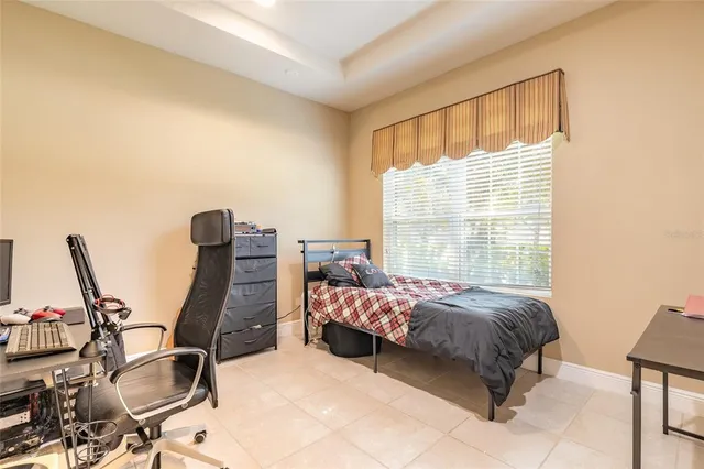 a bed room with a bed and a chair