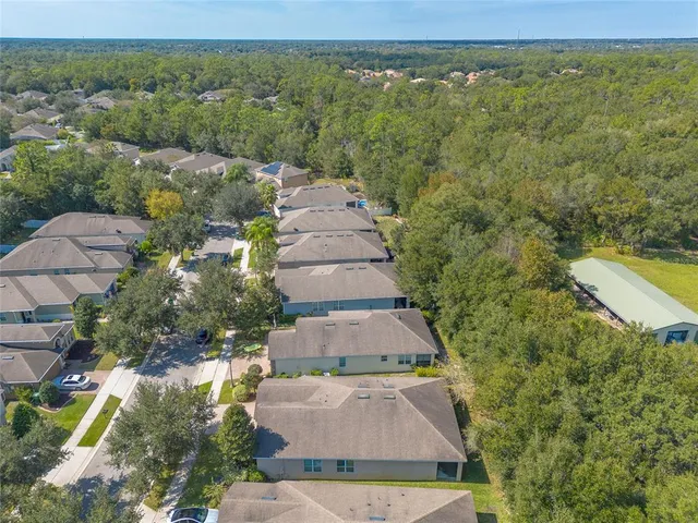 an aerial view of a house with a yard