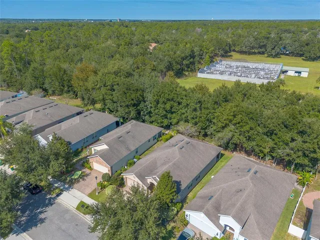 an aerial view of a house with big yard