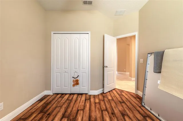 a view of a room with wooden floor and gate