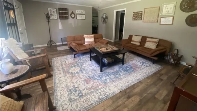 a living room with furniture and a rug