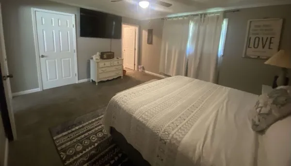 a bedroom with a bed and mirror