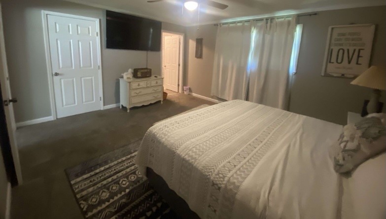 9743 Westbend Road Orange, TX 77632 - Photo 18 of 24 a bedroom with a bed and mirror