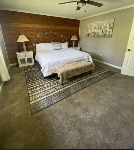 9743 Westbend Road Orange, TX 77632 - Photo 20 of 24 a spacious bedroom with a bed and a chandelier