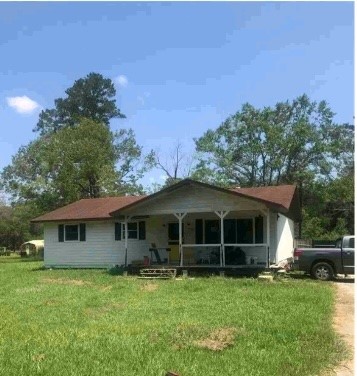 9743 Westbend Road Orange, TX 77632 - Photo 2 of 24 a front view of a house with a garden