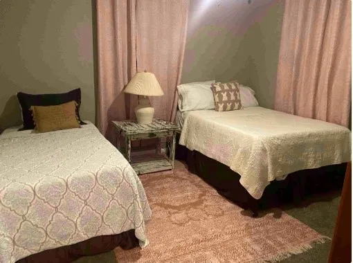 a bedroom with a bed and a lamp