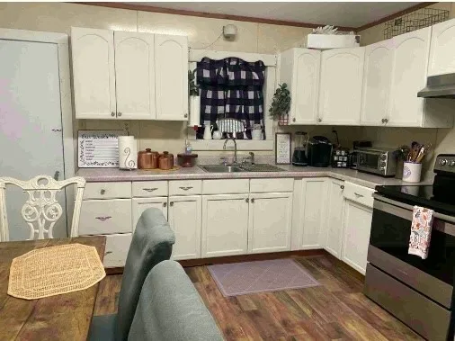 a kitchen with a sink stove and cabinets