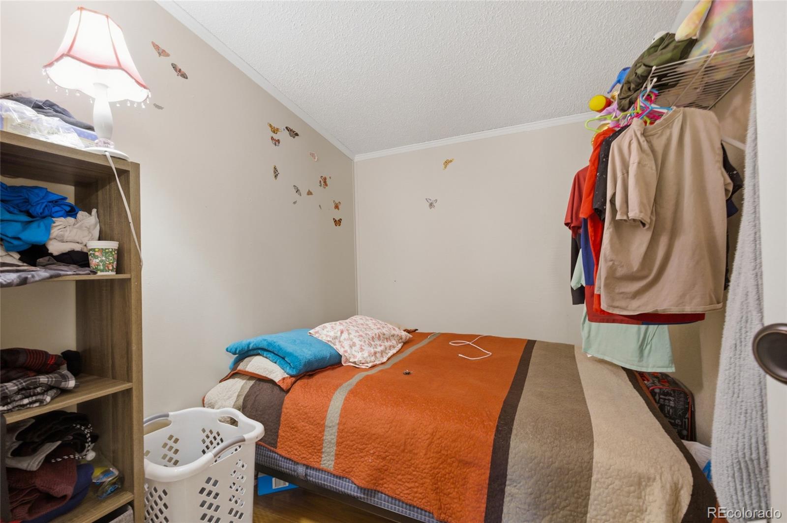 1724 Clark Street Aurora, CO 80011 - Photo 11 of 19 a bedroom with a bed and a closet