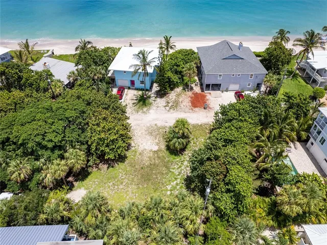 an aerial view of a house with a yard and lake view