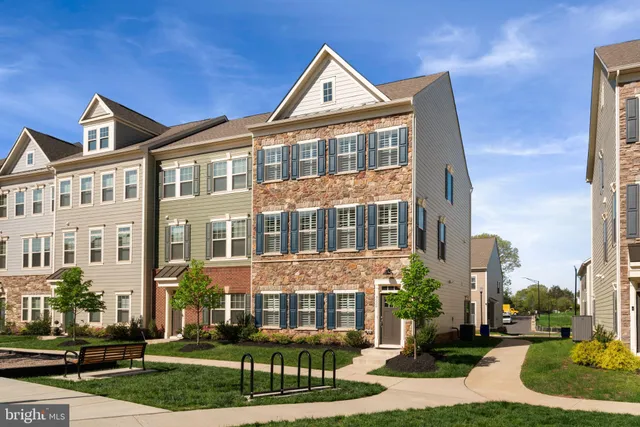 a front view of a residential apartment building with a yard
