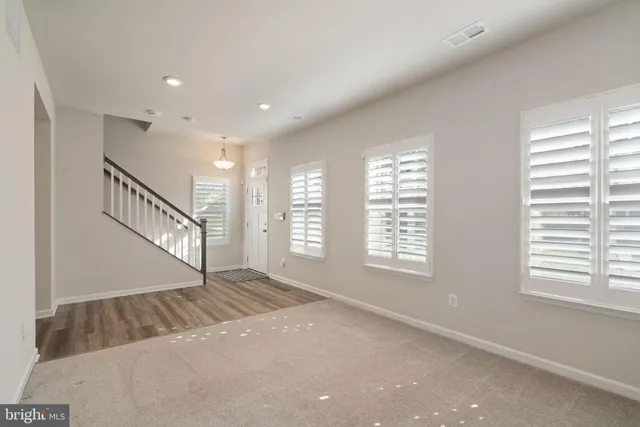 a view of an empty room with windows