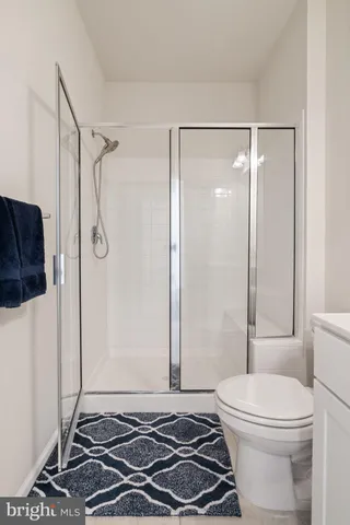 a bathroom with a toilet and a shower
