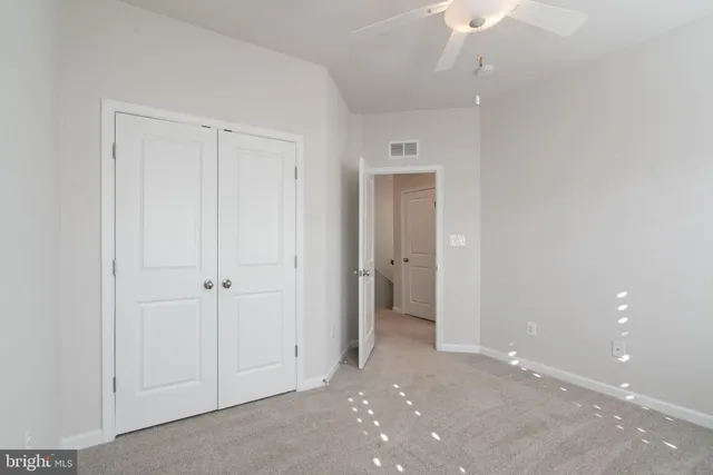 a view of an empty room and closet area