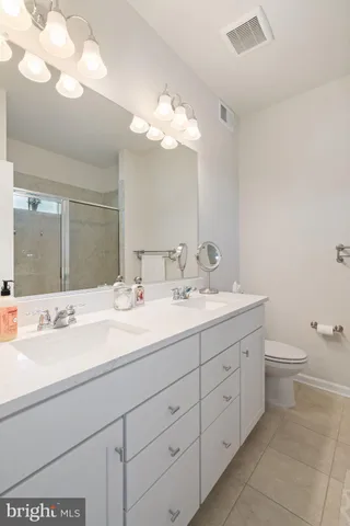 a bathroom with a double vanity sink and a mirror