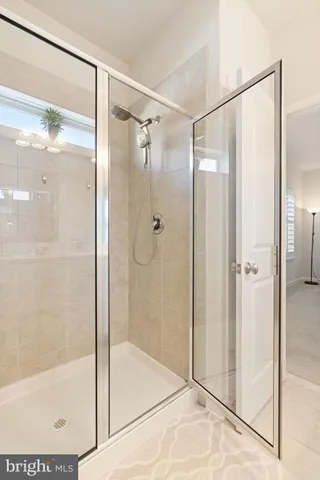 a bathroom with a glass shower door
