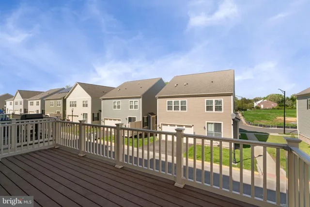 a view of a house with wooden fence