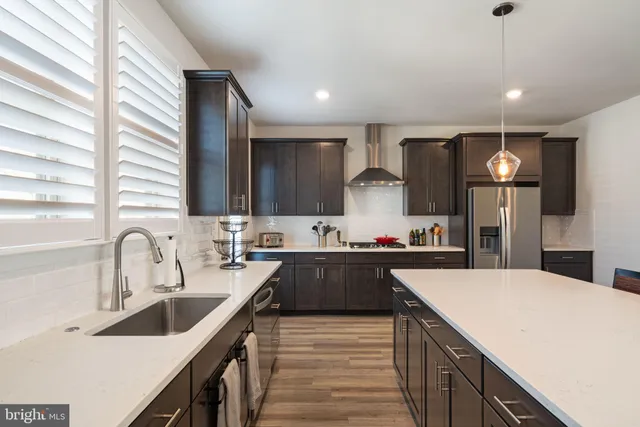 a kitchen with counter top space a sink cabinets and appliances