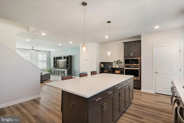 a large kitchen with kitchen island a sink counter space and stainless steel appliances