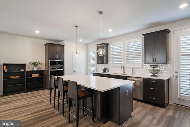a large kitchen with a table and chairs