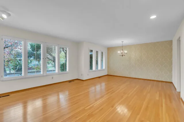 an aerial view of residential houses with outdoor space and trees