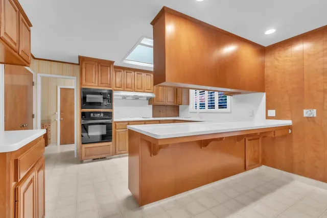 a kitchen with cabinets and a refrigerator