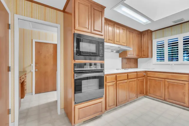 a bathroom with a granite countertop toilet and a sink
