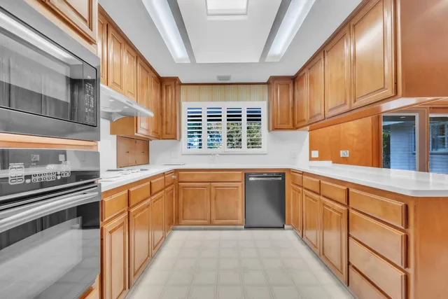 a view of wooden cabinets and a window