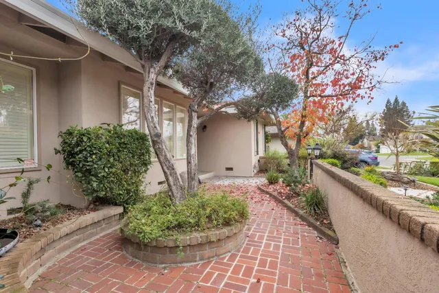 a view of a patio with table and chairs with wooden floor and fence