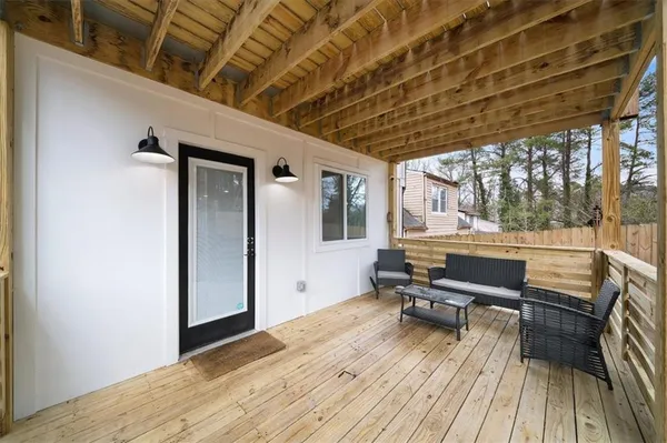 a view of a room with wooden floor and furniture