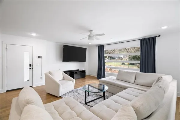 a living room with furniture and a flat screen tv