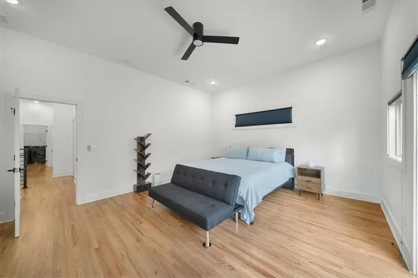 a spacious bedroom with a bed and a table