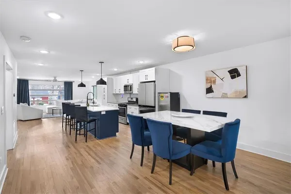 a view of a dining room with furniture and wooden floor