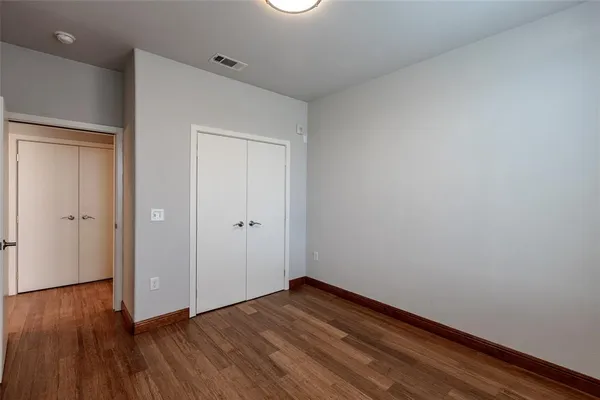a view of room with wooden floor