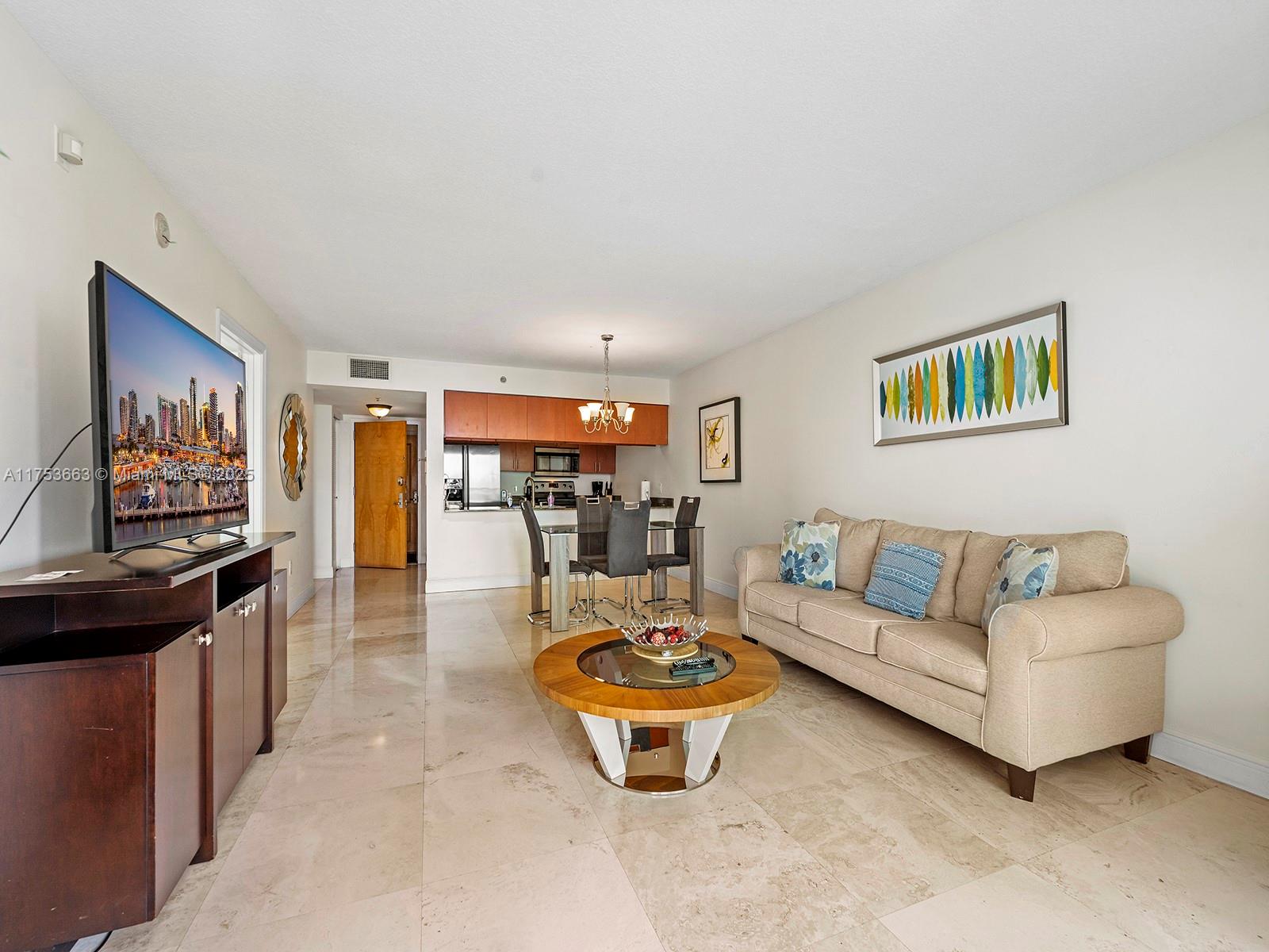 1200 Brickell Bay Drive, Unit 4019 Miami, FL 33131 - Photo 14 of 32 a living room with furniture and a view of kitchen