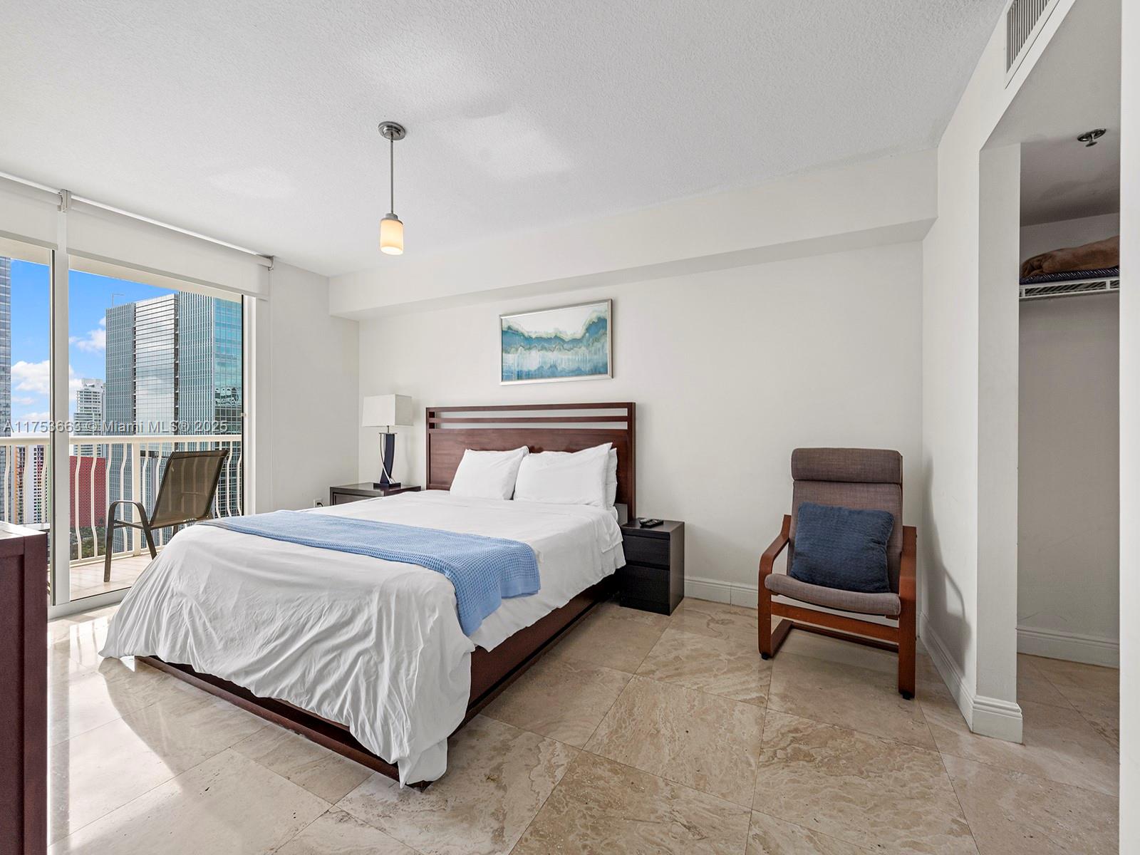 1200 Brickell Bay Drive, Unit 4019 Miami, FL 33131 - Photo 19 of 32 a bedroom with a bed and a window