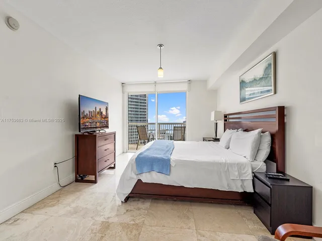 a bedroom with bed and a night stand