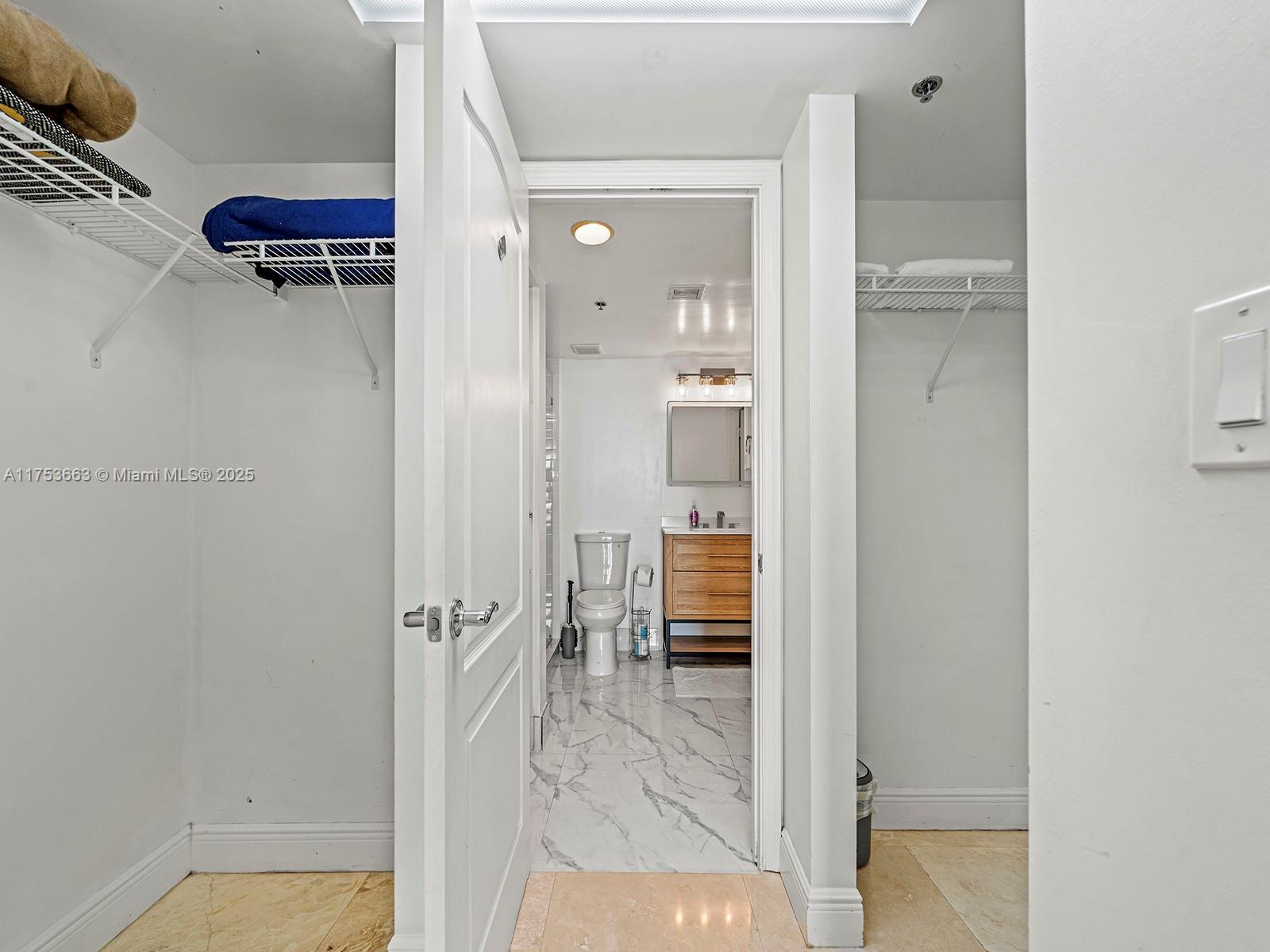 1200 Brickell Bay Drive, Unit 4019 Miami, FL 33131 - Photo 22 of 32 wooden floor with a bathroom